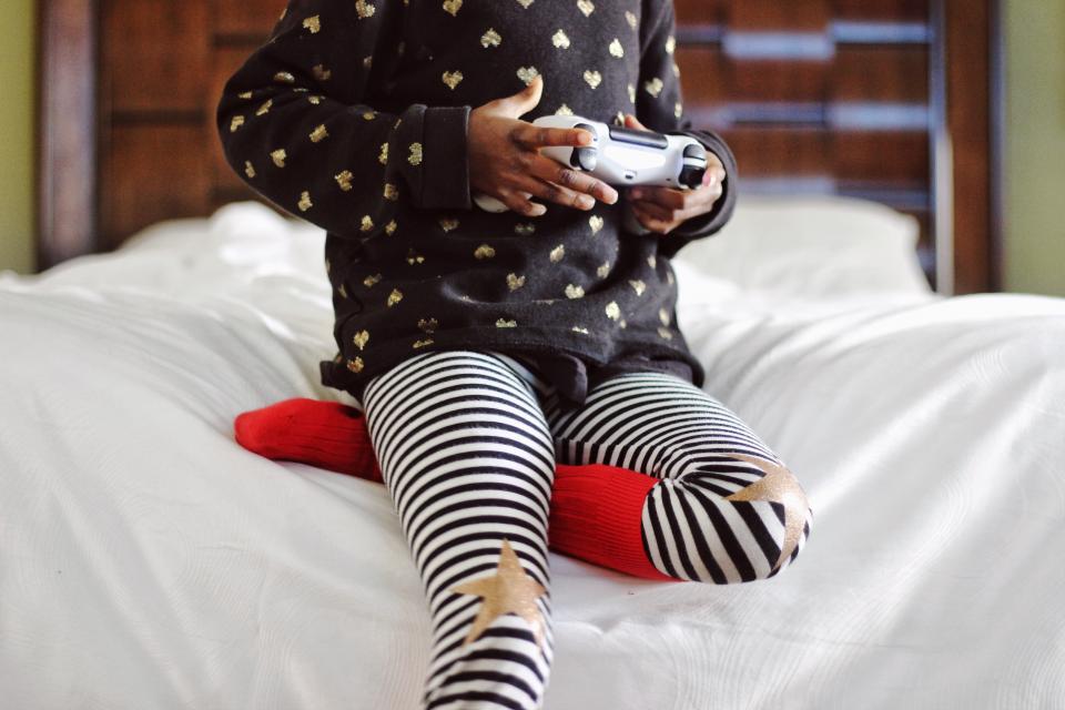 A child using a tablet, illustrating the head-down posture that contributes to tech neck